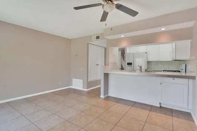 a kitchen with cabinets and window