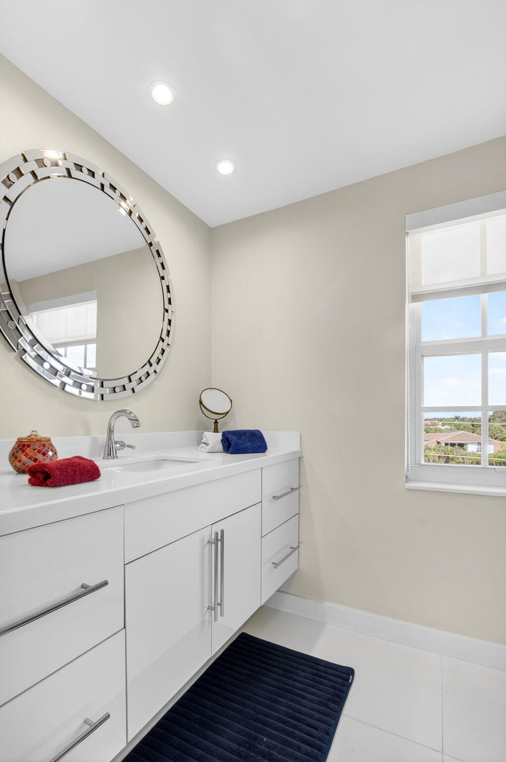 950 De Soto Road, Unit 5A Boca Raton, FL 33432 - Photo 45 of 98 a bathroom with a sink and a mirror