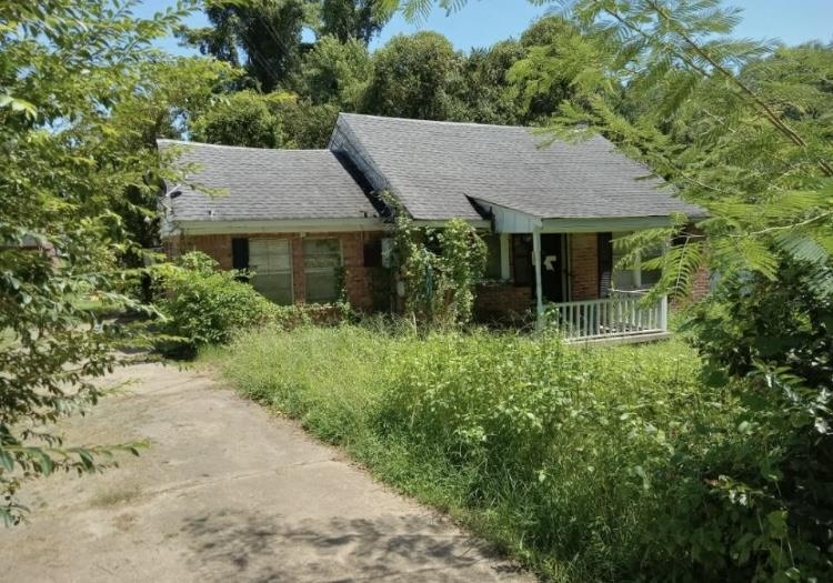 5224 Tulip Road Memphis, TN 38109 - Photo 1 of 4 an aerial view of a house with yard and trees in the background