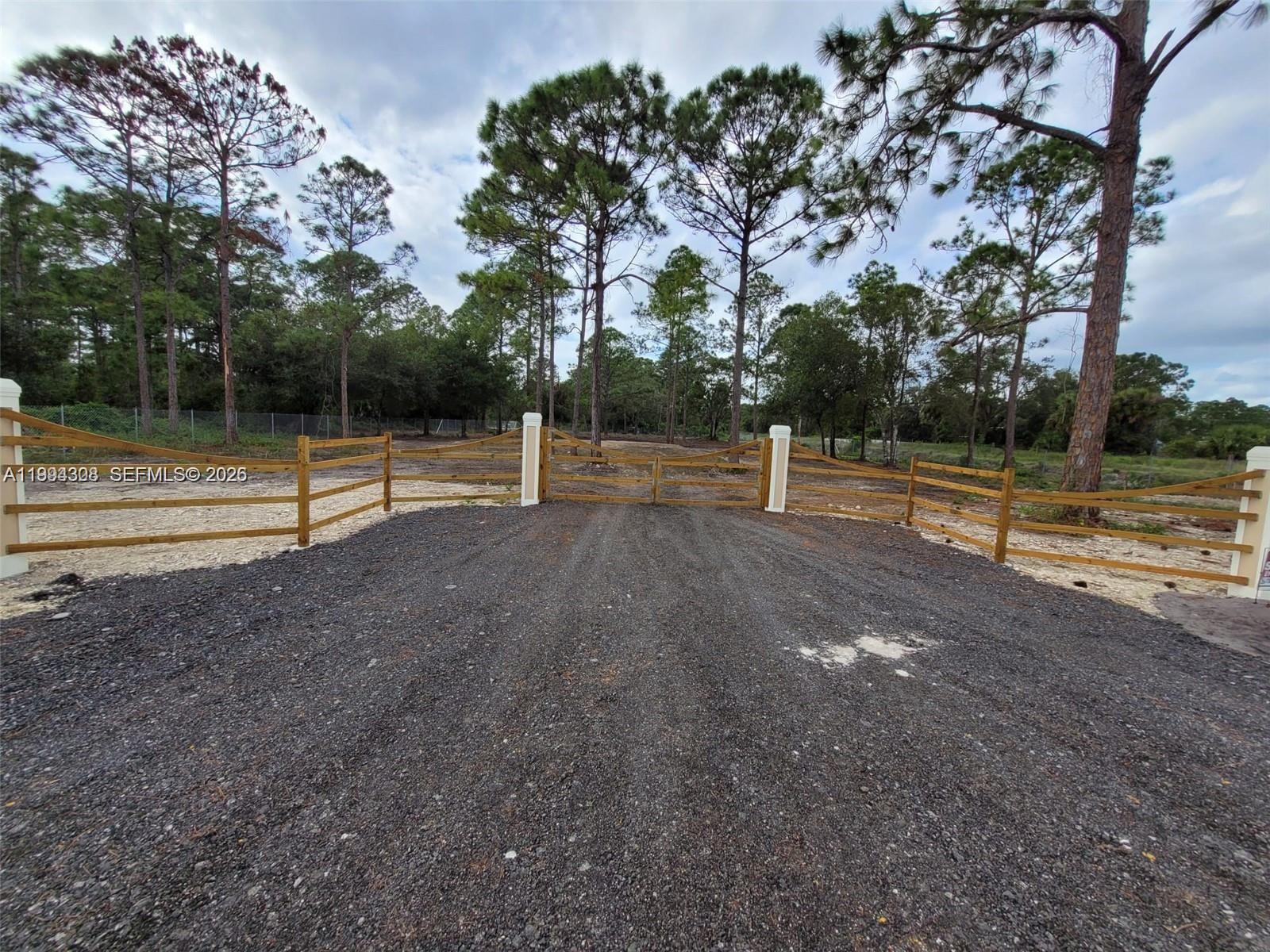 610 South Quebrada Street Clewiston, FL 33440 - Photo 6 of 10 a view of outdoor space with deck and trees
