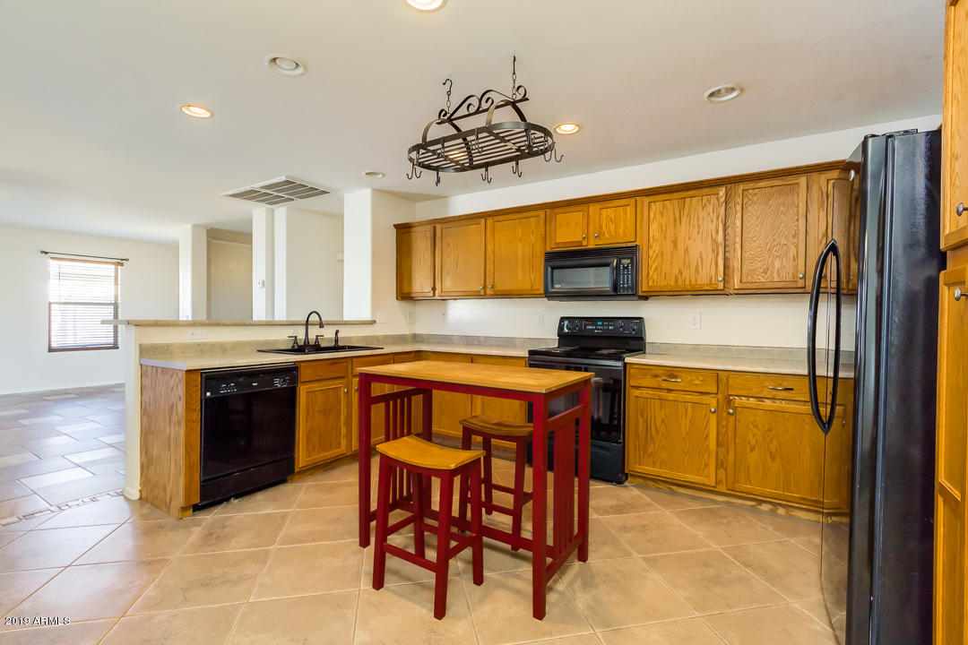 1986 West Tanner Ranch Road Queen Creek, AZ 85144 - Photo 15 of 32 a kitchen with stainless steel appliances granite countertop a stove a sink and a refrigerator