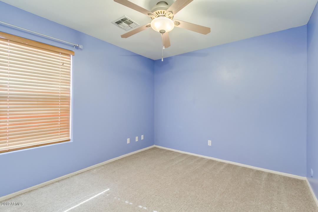 1986 West Tanner Ranch Road Queen Creek, AZ 85144 - Photo 25 of 32 an empty room with a window and a fan