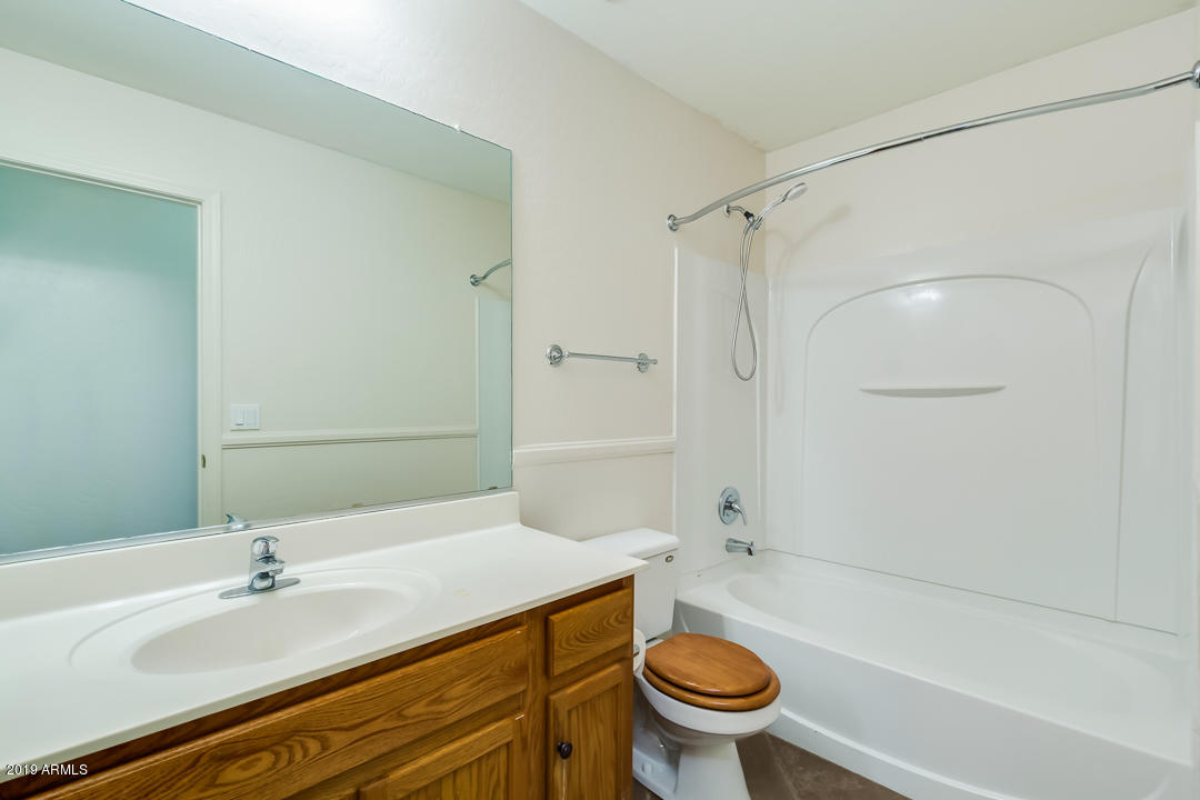 1986 West Tanner Ranch Road Queen Creek, AZ 85144 - Photo 27 of 32 a bathroom with a sink a toilet and a bathtub