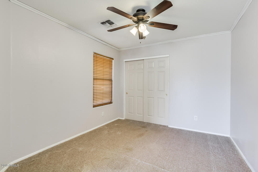 1986 West Tanner Ranch Road Queen Creek, AZ 85144 - Photo 4 of 32 an empty room with a window and a fan