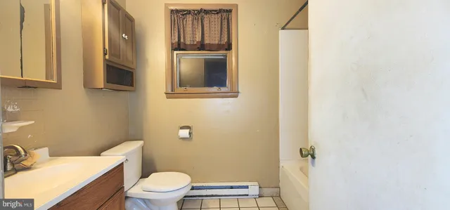 a white toilet sitting next to a bathroom sink
