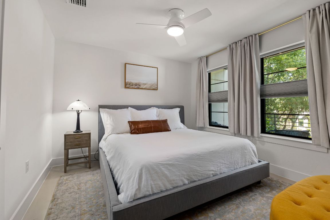 3700 Clawson Road, Unit 503 Austin, TX 78704 - Photo 14 of 39 a bedroom with a bed lamps and window