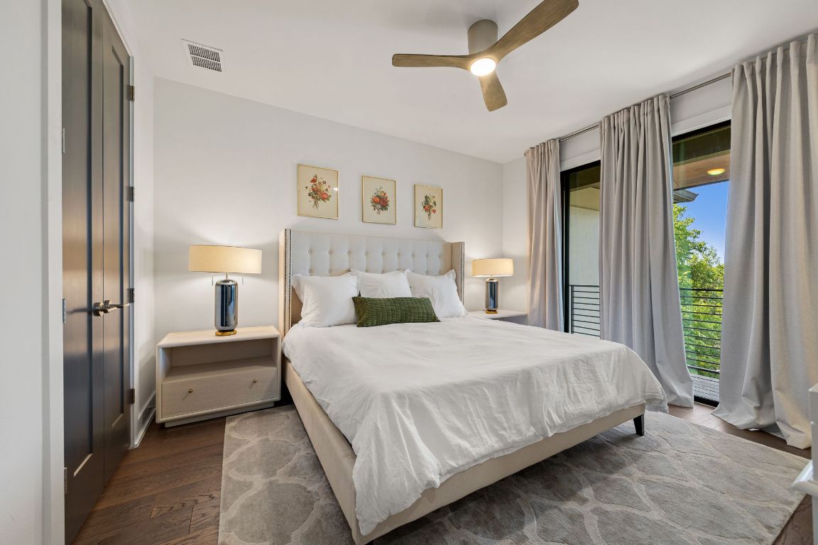 3700 Clawson Road, Unit 503 Austin, TX 78704 - Photo 17 of 39 a bedroom with a large bed and a chandelier