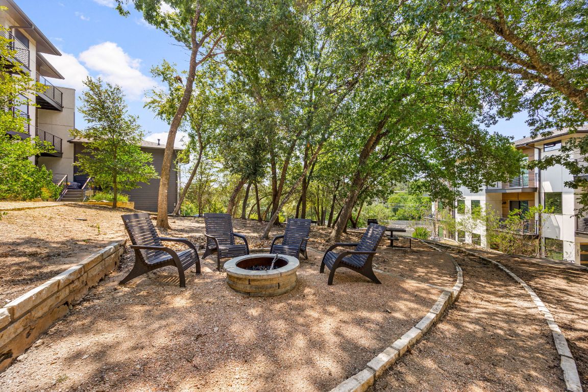 3700 Clawson Road, Unit 503 Austin, TX 78704 - Photo 30 of 39 a view of a backyard with table and chairs and a barbeque with potted plants and large trees