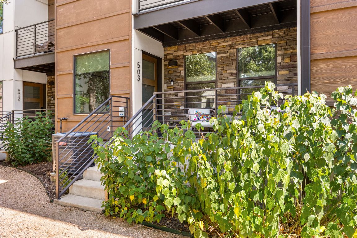 3700 Clawson Road, Unit 503 Austin, TX 78704 - Photo 33 of 39 a flower garden with a bench in front of it