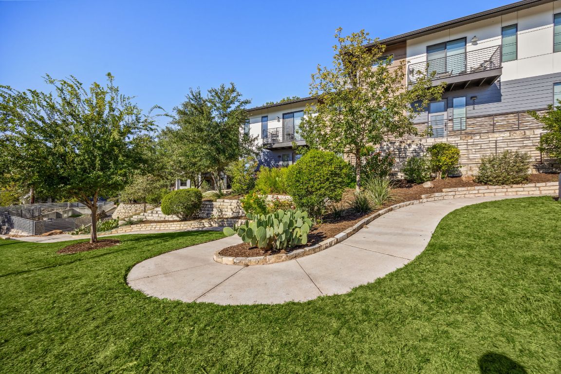 3700 Clawson Road, Unit 503 Austin, TX 78704 - Photo 36 of 39 a view of a backyard with plants and brick wall