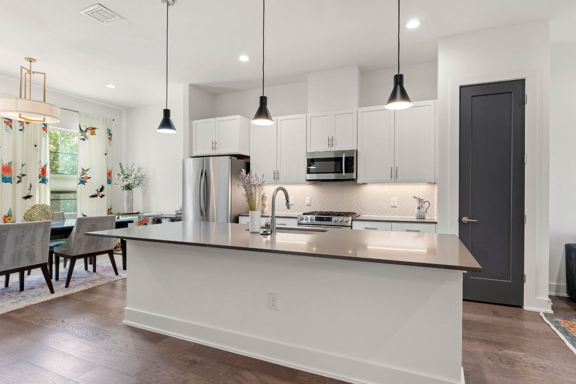 3700 Clawson Road, Unit 503 Austin, TX 78704 - Photo 6 of 39 a kitchen with stainless steel appliances kitchen island a refrigerator sink and cabinets