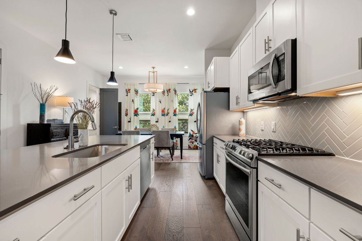 3700 Clawson Road, Unit 503 Austin, TX 78704 - Photo 10 of 39 a kitchen with stainless steel appliances granite countertop a sink a stove and a wooden floors