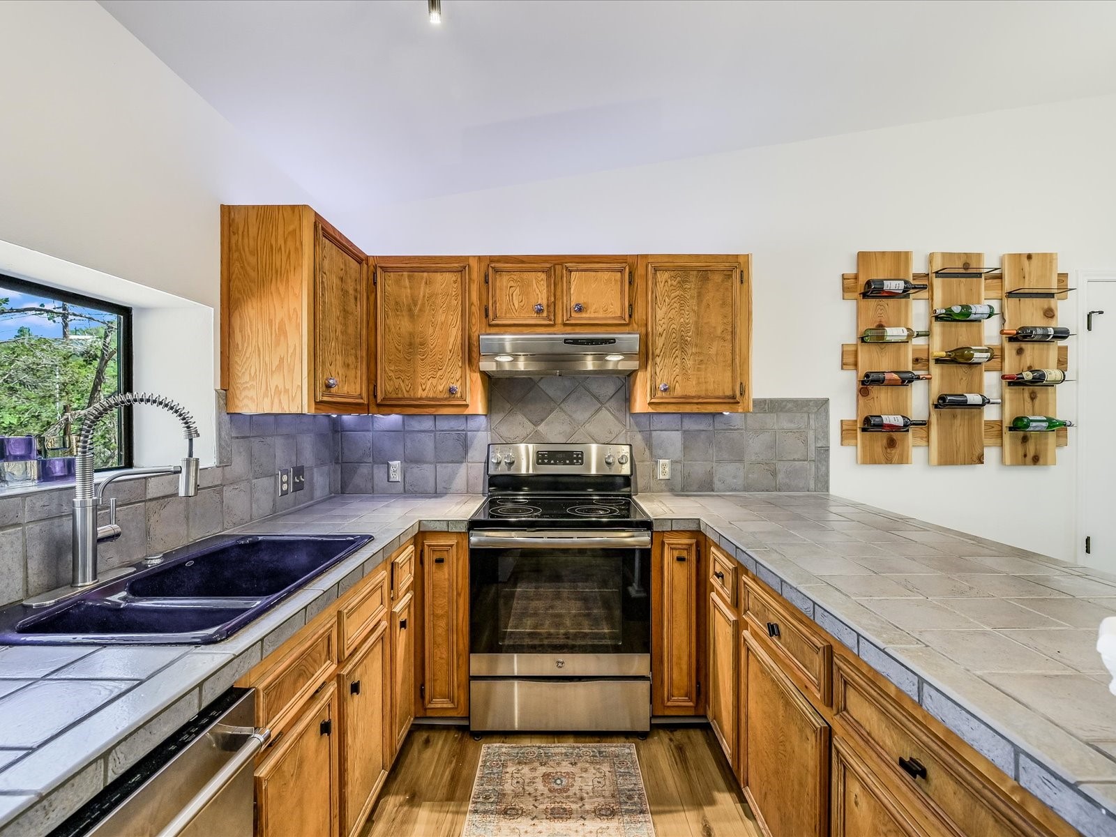 2712 Geronimo Trail Austin, TX 78734 - Photo 13 of 31 a kitchen with stainless steel appliances granite countertop a stove and a sink