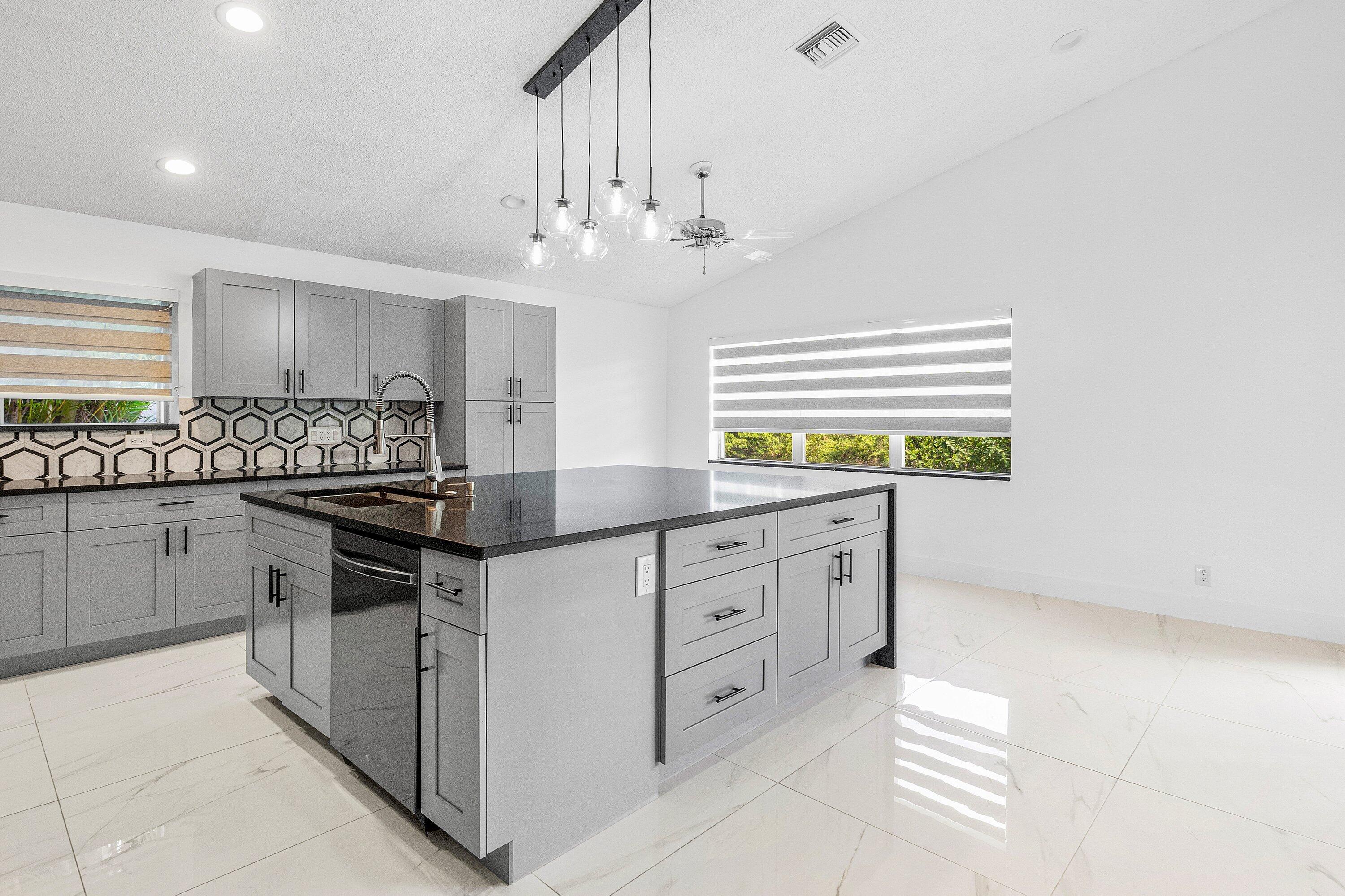 11163 180th Court South Boca Raton, FL 33498 - Photo 10 of 22 a kitchen with granite countertop a sink and cabinets