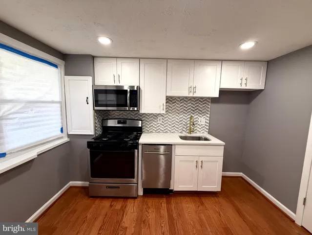 a kitchen with a stove and a microwave