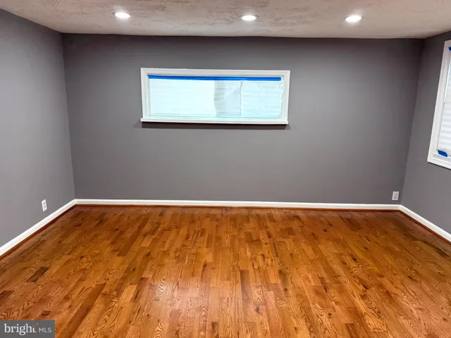 a view of room with wooden floor and window