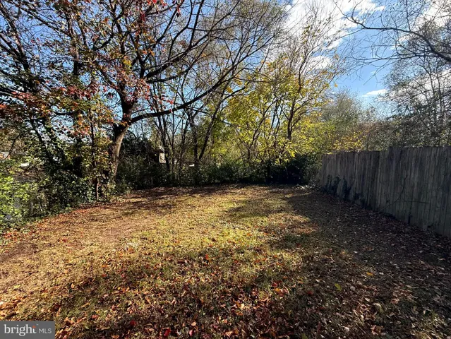 a view of house with a yard