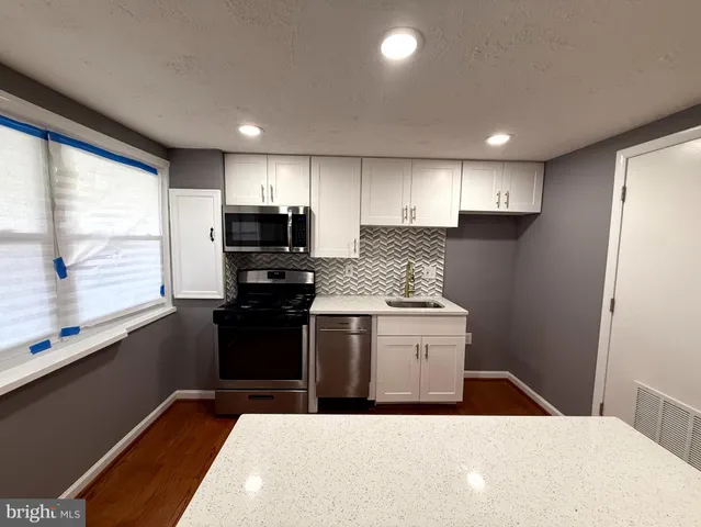 a kitchen with a stove and a microwave