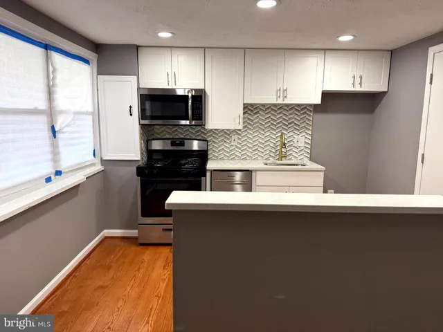 a kitchen with counter top space cabinets and stainless steel appliances