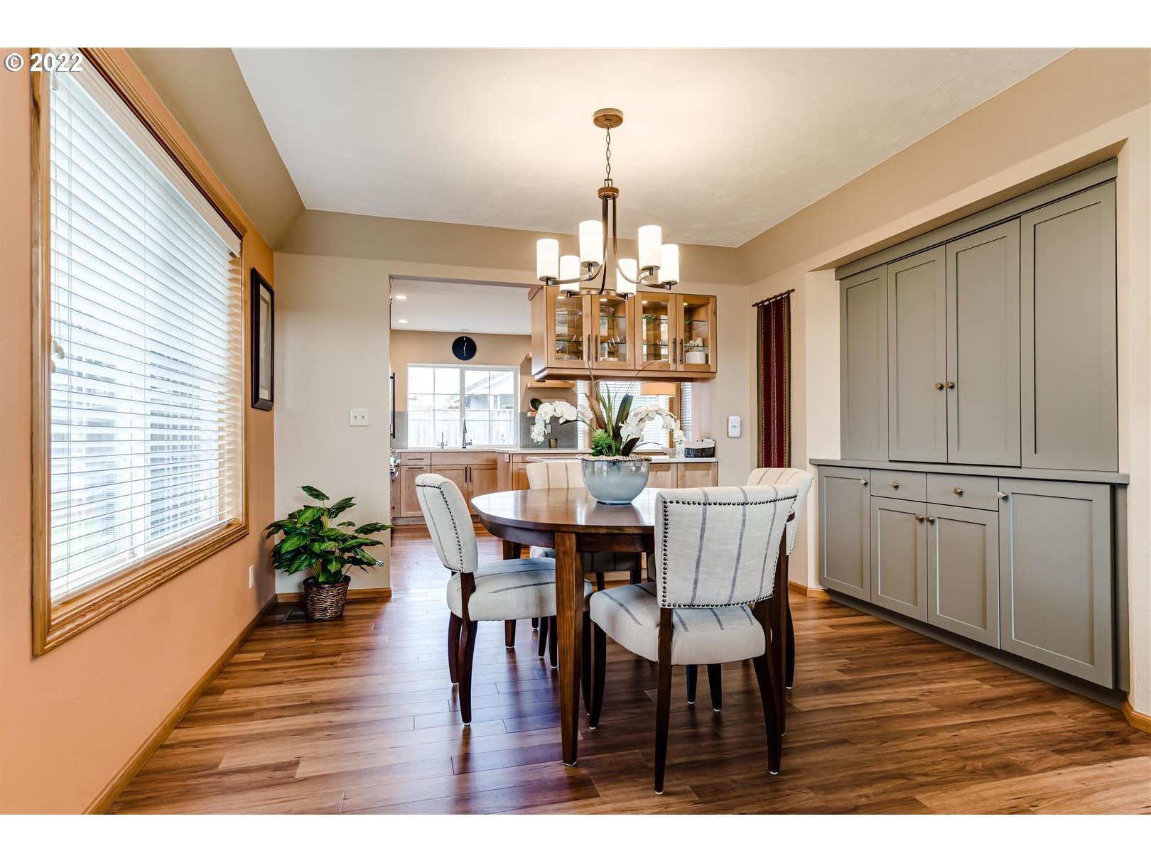 834 Raintree Way Springfield, OR 97477 - Photo 16 of 28 a dining room with wooden floor a chandelier a wooden table and chairs