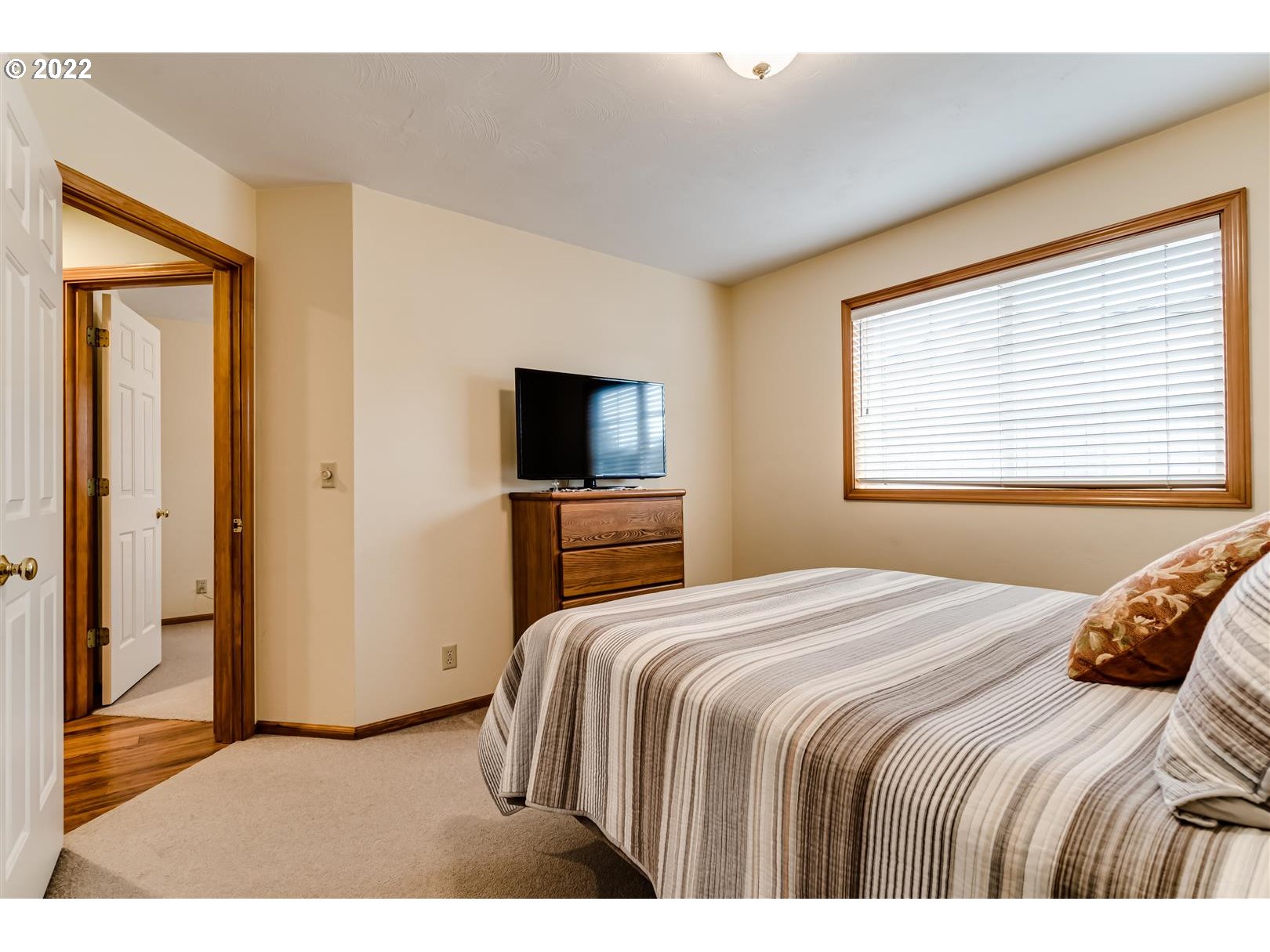 834 Raintree Way Springfield, OR 97477 - Photo 23 of 28 a bedroom with a bed and a tv