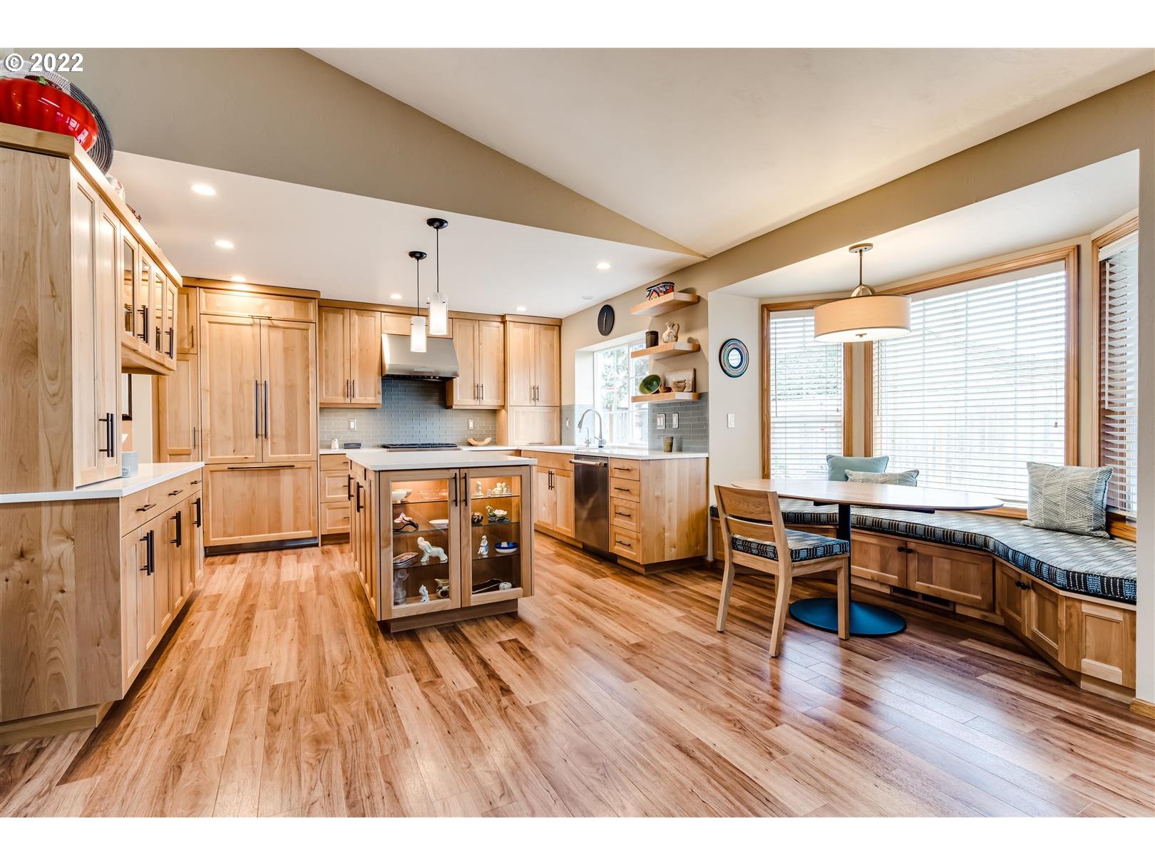 834 Raintree Way Springfield, OR 97477 - Photo 10 of 28 a living room with stainless steel appliances kitchen island granite countertop furniture a large window and wooden floor
