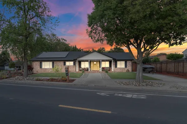 a front view of a house with a yard
