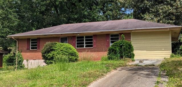 2196 Rosewood Road Decatur, GA 30032 - Photo 1 of 1 a view of a house with a small yard plants and large tree
