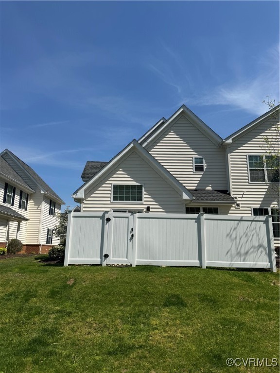 1802 Rustads Circle Williamsburg, VA 23188 - Photo 26 of 26 Back of house featuring a lawn, roof with shingles
