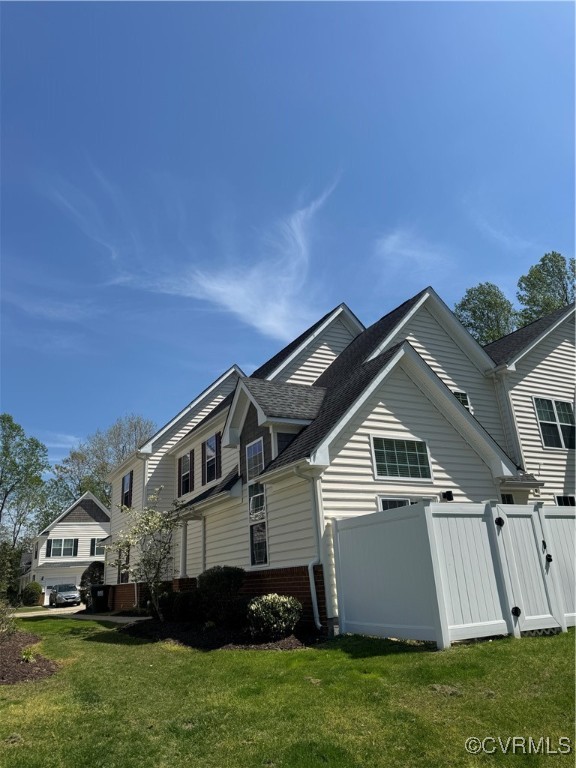 1802 Rustads Circle Williamsburg, VA 23188 - Photo 3 of 26 View of property exterior featuring fence, roof wi