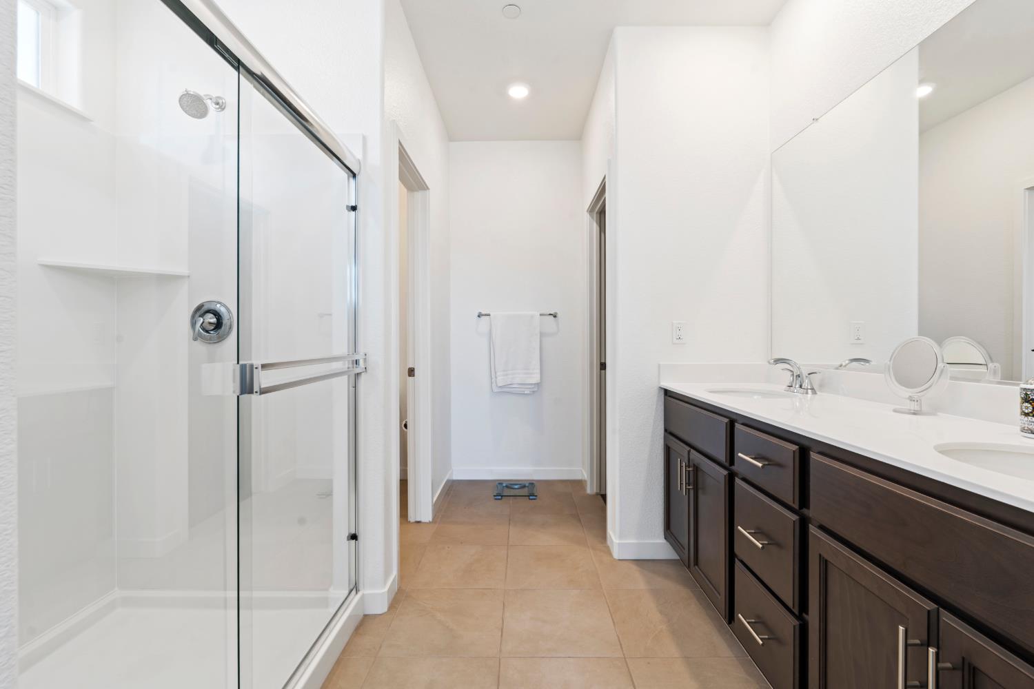 5713 Natalie Way Keyes, CA 95328 - Photo 11 of 30 a spacious bathroom with a shower sink and mirror