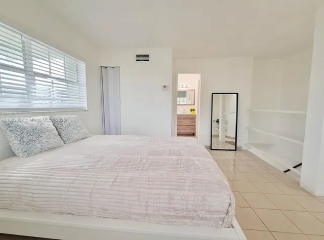a bedroom with a bed and cabinets