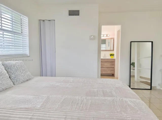 a bathroom with a tub and mirror