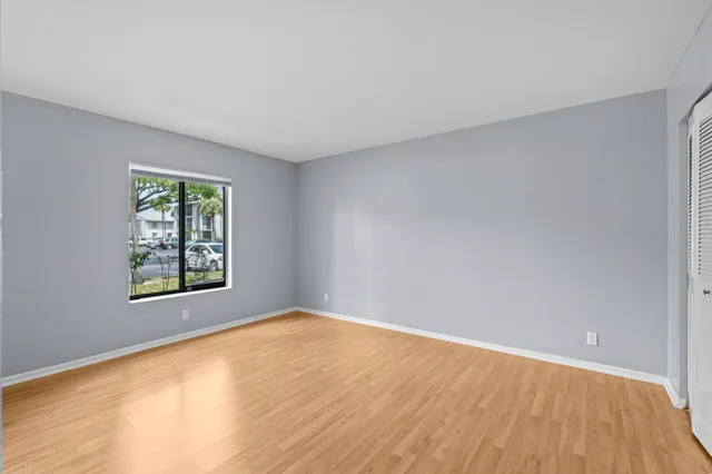 a view of an empty room and wooden floor