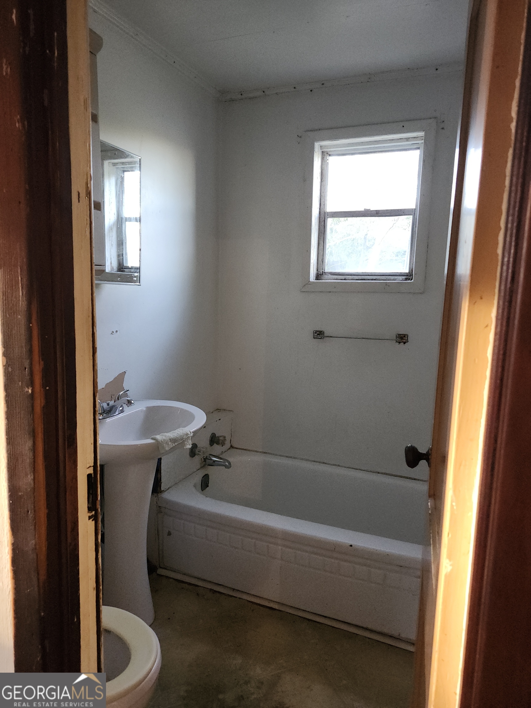 1121 Carroll Street Macon, GA 31206 - Photo 2 of 10 a bathroom with a toilet and a bathtub