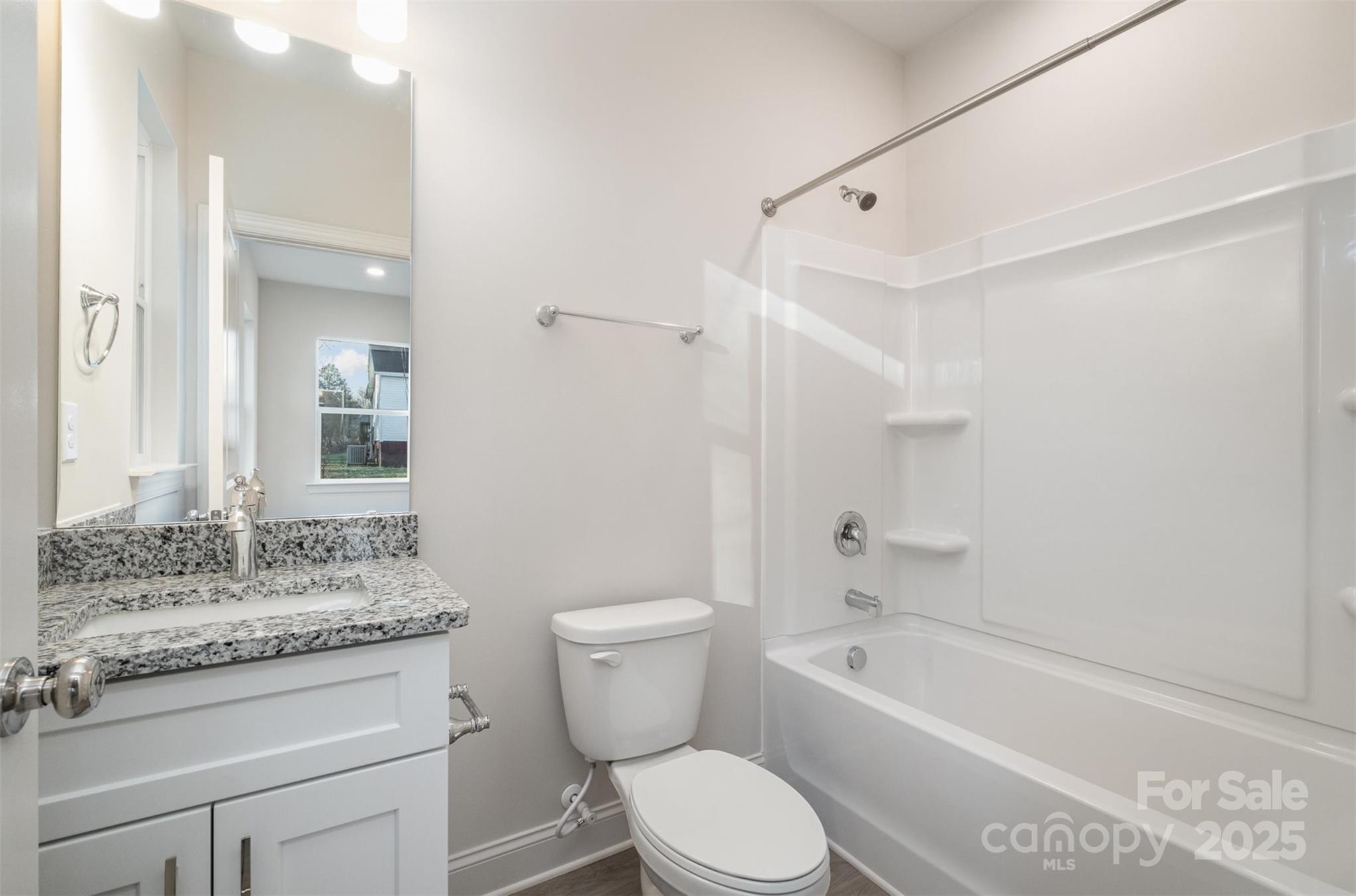 203 William Street York, SC 29745 - Photo 11 of 17 a bathroom with a granite countertop toilet a sink and a bathtub