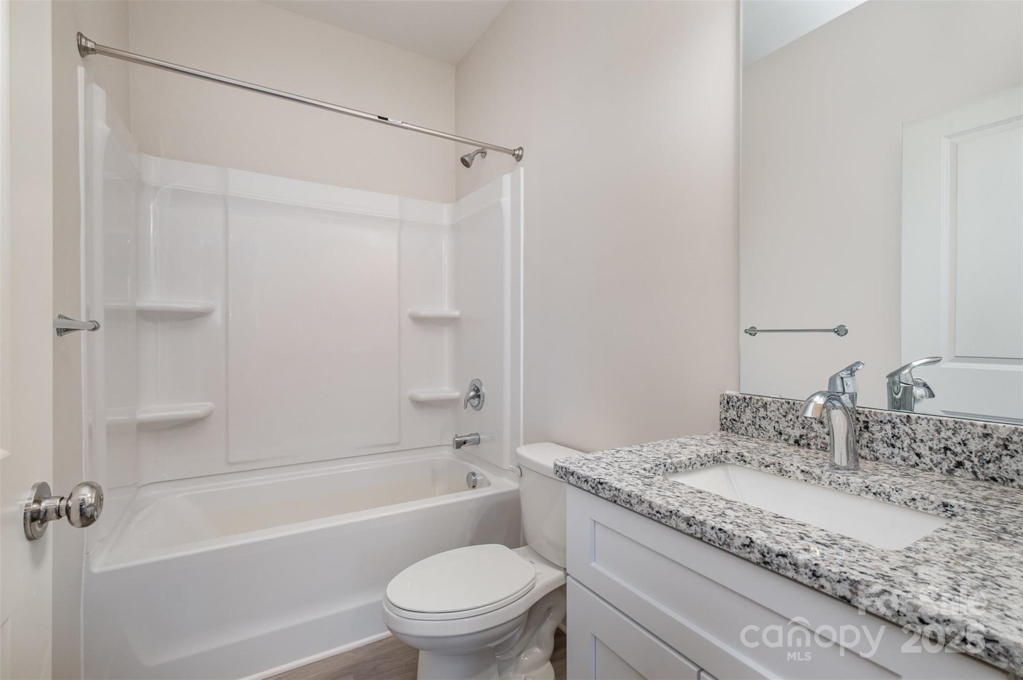 203 William Street York, SC 29745 - Photo 14 of 17 a bathroom with a granite countertop sink a toilet and shower