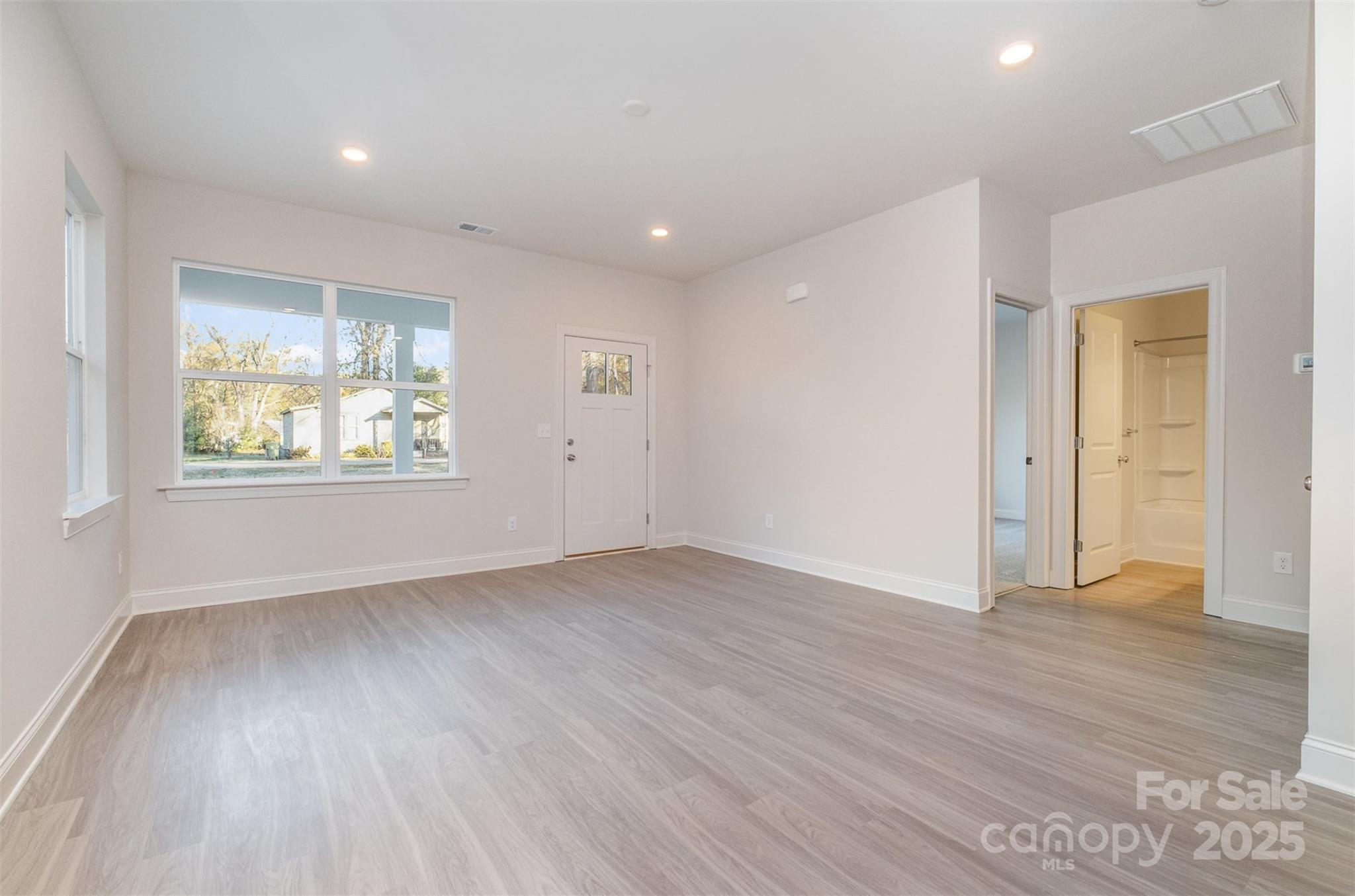 203 William Street York, SC 29745 - Photo 3 of 17 an empty room with wooden floor and windows