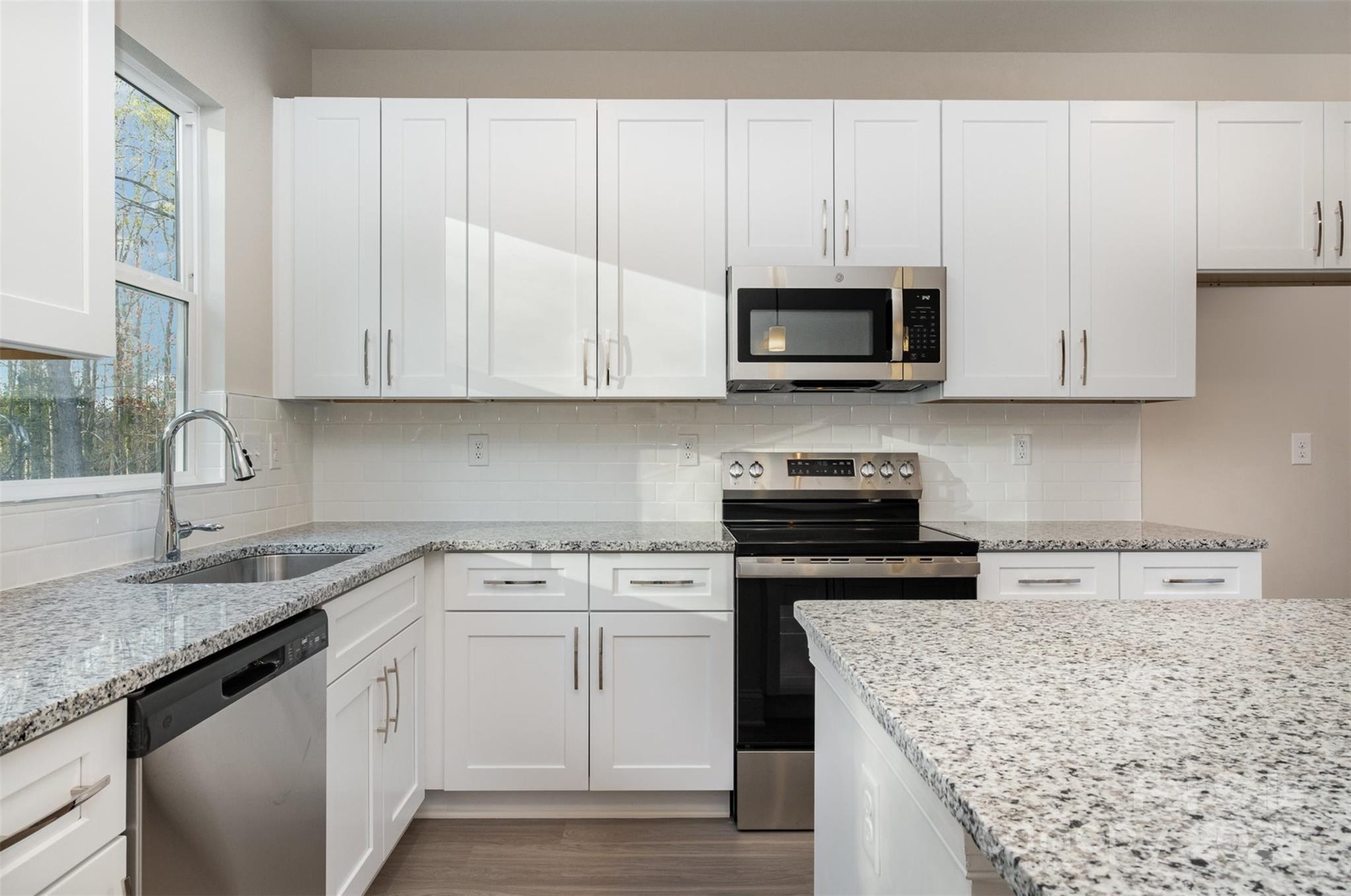 203 William Street York, SC 29745 - Photo 6 of 17 a kitchen with stainless steel appliances granite countertop a sink stove and microwave
