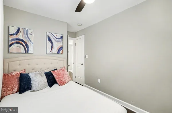 a bedroom with a bed and a painting on the wall