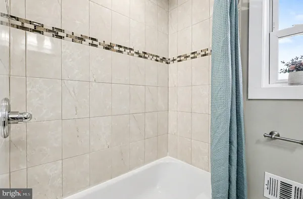 a bathroom with a shower and a bathtub