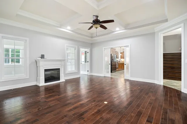 a kitchen with stainless steel appliances kitchen island granite countertop a table chairs and a refrigerator
