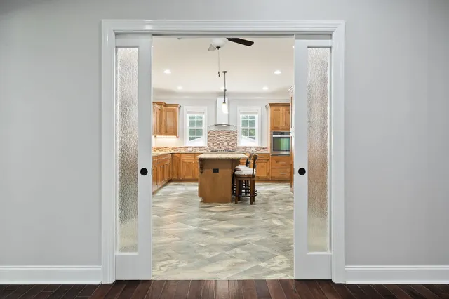a large kitchen with a table and chairs in it