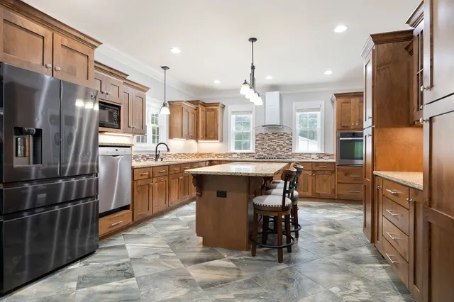 a bathroom with a granite countertop sink and a window