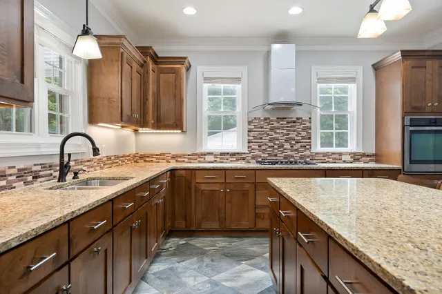 a kitchen with a sink counter and chairs