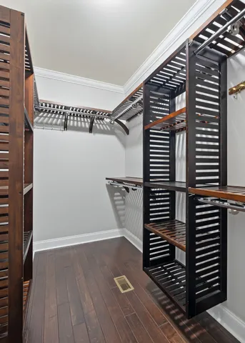 a view of a small space with wooden floor and windows