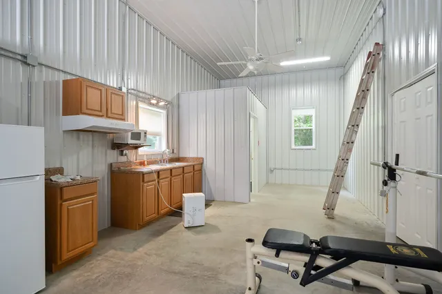 a view of a lush green field with lots of bushes