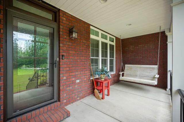 a view of a house with porch and garden