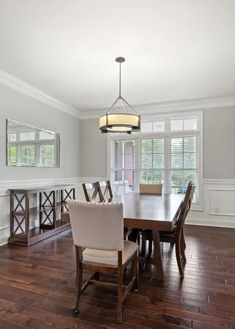 a view of a dining room with furniture wooden floor and chandelier