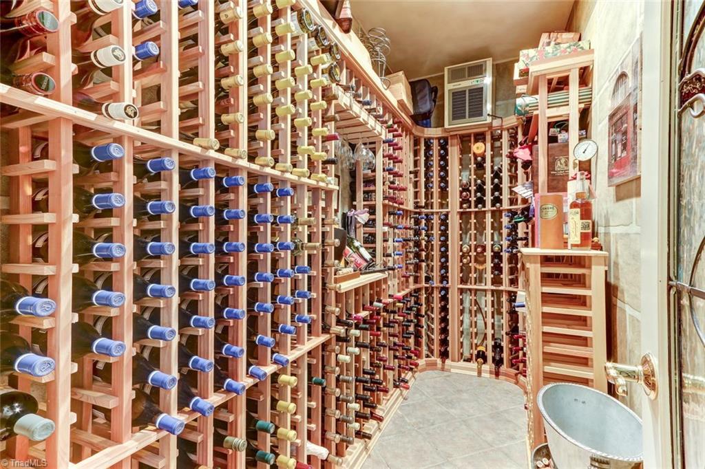 6310 Hunt Road Pleasant Garden, NC 27313 - Photo 11 of 30 Perfect for the collector or wine connoisseur! Climatized wine room that holds up to 800 bottles. Located just off the kitchen with a decorative leaded glass door. Custom cedar racks, tile floor and a built in cooler.
